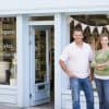 couple standing in front of small business